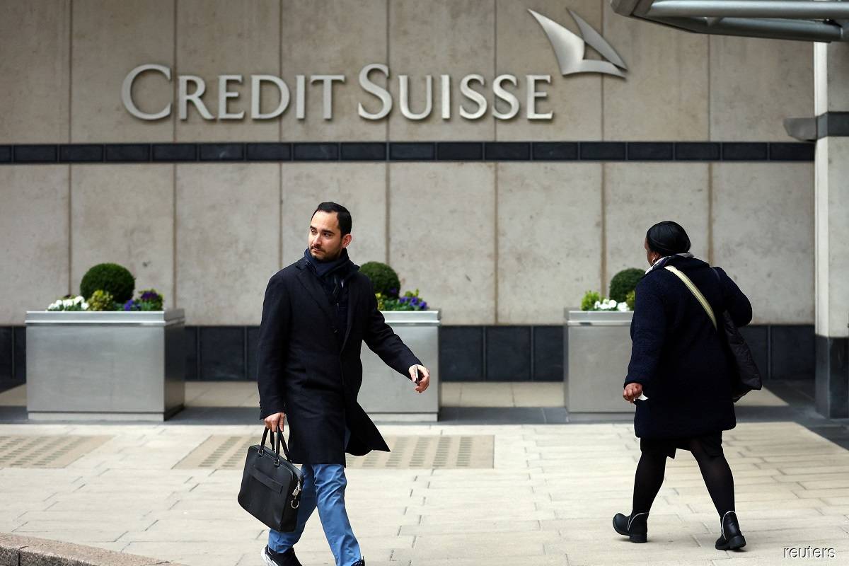 People walking past the Credit Suisse office in Canary Wharf in London on March 20, 2023. (Reuters pic)